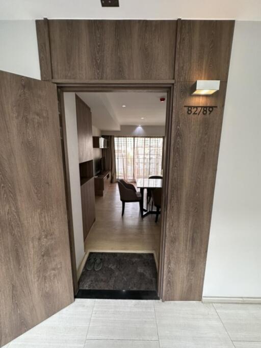 Entrance to a modern apartment with a view of the living room area