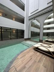 Indoor swimming pool area with lounge chairs