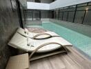 Indoor pool area with lounge chairs