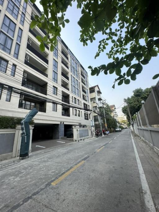 Street view of a modern multi-story apartment building