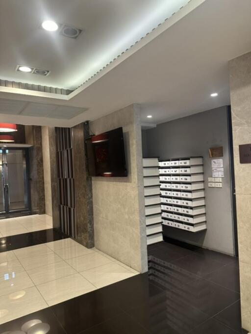 Lobby with mailboxes and a flat-screen TV