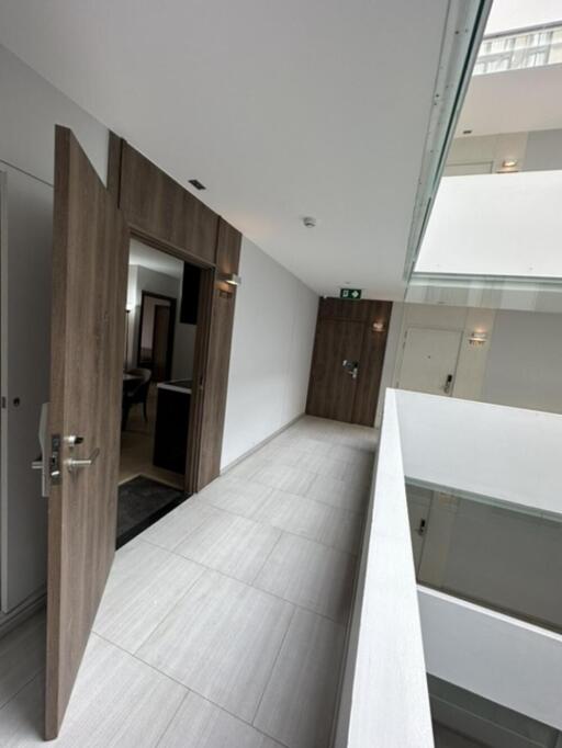 Modern hallway with open door and skylight