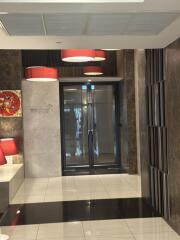 Lobby area with modern decor and double glass doors