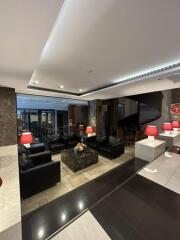 Modern lounge area with leather seating and red lamps