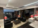 Modern lounge area with leather seating and red lamps