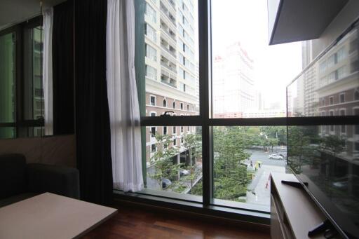 Living room with large window and city view