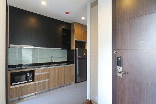 Modern kitchen with built-in appliances and wooden cabinets