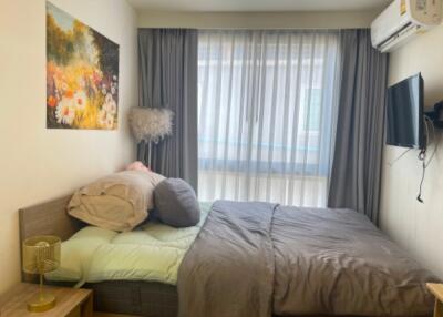 Cozy bedroom with a double bed and wall-mounted TV