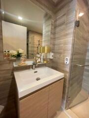 Modern bathroom with sink, mirror, and shower