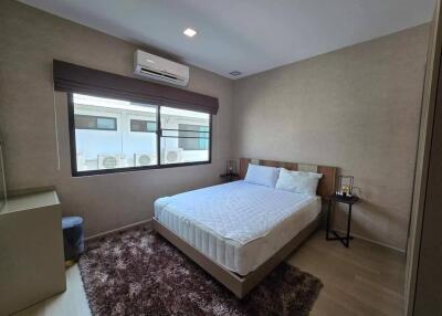 Spacious bedroom with large window and air conditioning