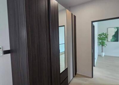 Modern hallway with closet and view to living area