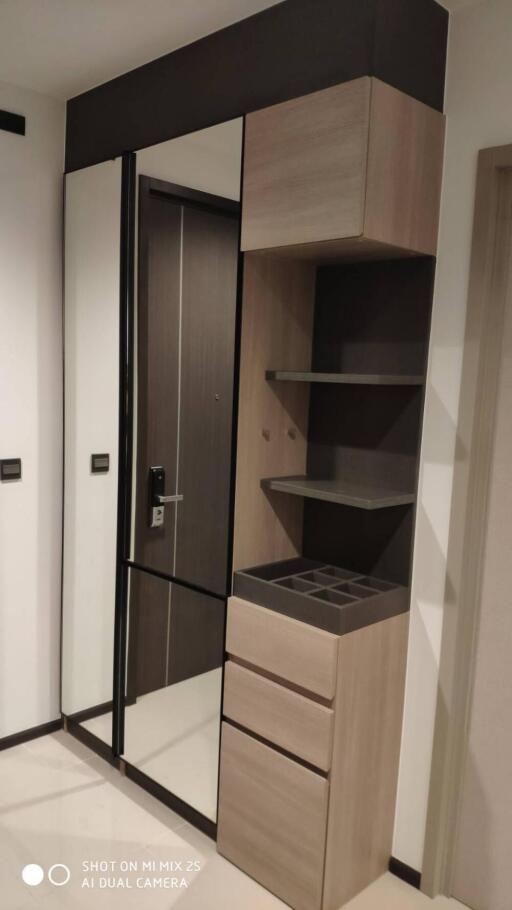 Modern hallway with mirror and storage units