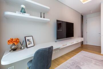 Modern living area with wall-mounted TV and shelves