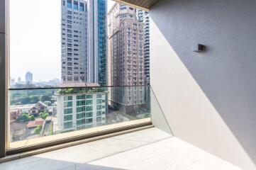 Modern balcony with glass railing and city view