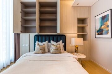 Modern bedroom with open shelves and a cozy bed