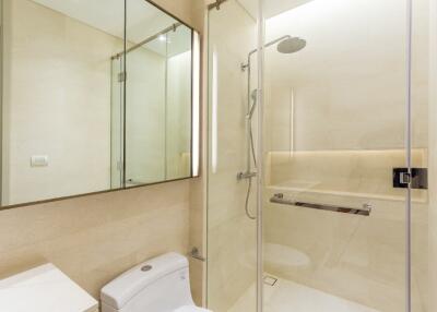 Modern bathroom with glass shower enclosure and wall-mounted toilet