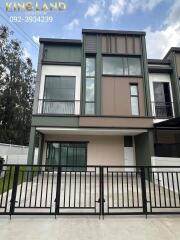 Modern two-story house with a gated driveway