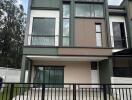 Modern two-story house with a gated driveway