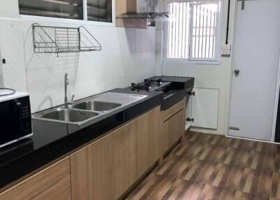 Modern kitchen with wooden cabinetry and countertop appliances