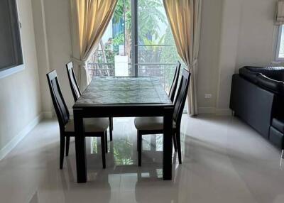 Modern dining area with glass table and black chairs