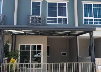 Front view of a modern townhouse with gated driveway