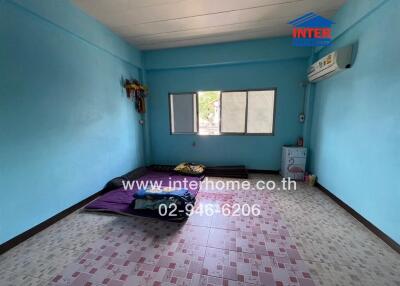 Bedroom with blue walls and windows