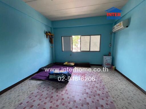 Bedroom with blue walls and windows