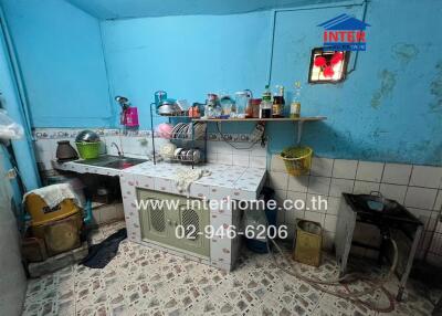 Old kitchen with blue walls and various utensils