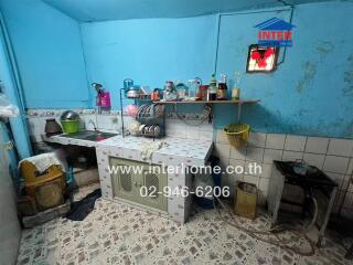 Old kitchen with blue walls and various utensils