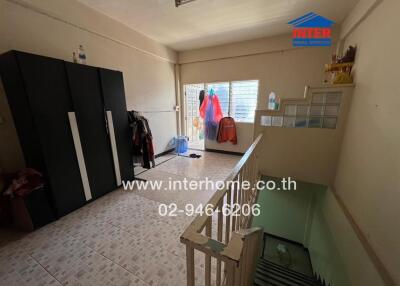 Bedroom with wardrobe and stair access