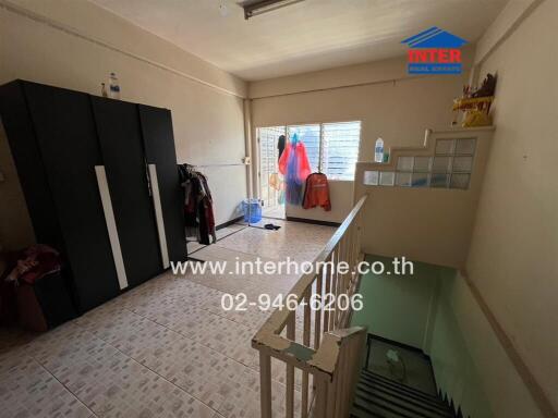 Bedroom with wardrobe and stair access