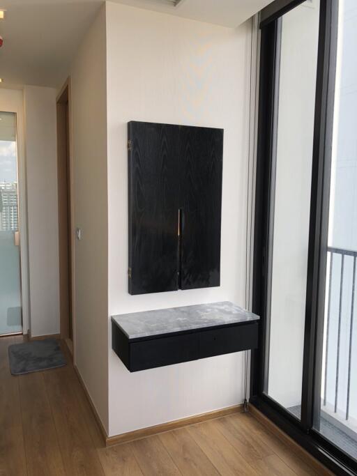 Modern hallway with wooden flooring and mounted cabinet