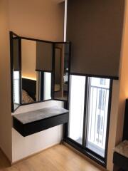 Bedroom with dressing table and balcony view