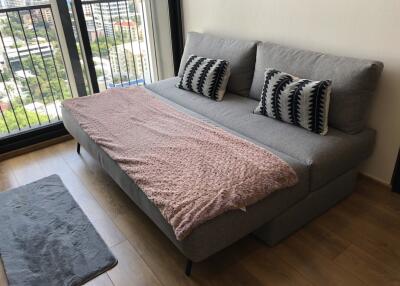 Cozy living room with a grey sofa bed and decorative pillows