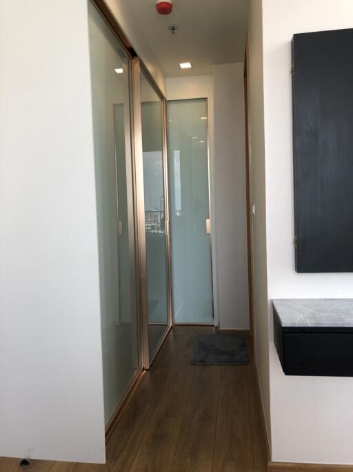 Modern hallway with wooden floors and sliding glass doors