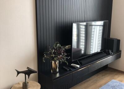 Modern living room with black feature wall and TV