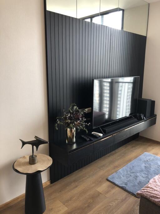 Modern living room with black feature wall and TV