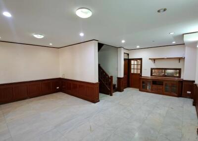 Spacious living room with wooden trim and staircase