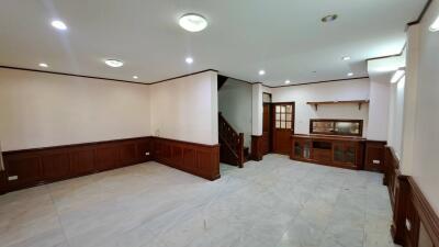 Spacious living room with wooden trim and staircase