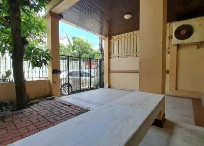 Covered outdoor area with tiled flooring, gate, and air conditioning unit