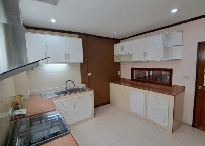 Modern kitchen with overhead cabinets and stainless steel sink