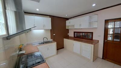 Modern kitchen with overhead cabinets and stainless steel sink