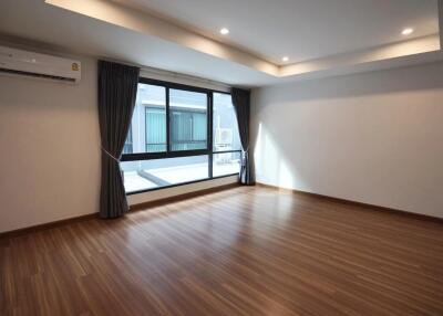 Spacious living room with wooden flooring and large window