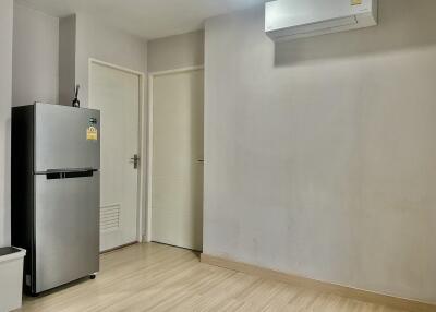 Modern kitchen with stainless steel refrigerator and air conditioning