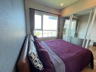 Bedroom with large window and glass door to balcony