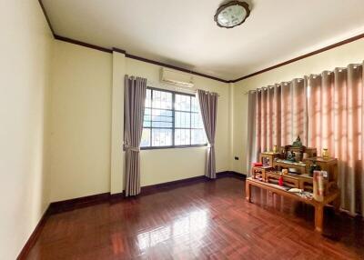 Spacious living room with a window and wooden flooring