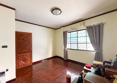 Spacious living room with wooden flooring and large window