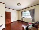 Spacious living room with wooden flooring and large window