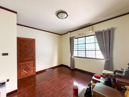 Spacious living room with wooden flooring and large window