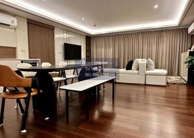 Modern living room with dining area and wooden floors